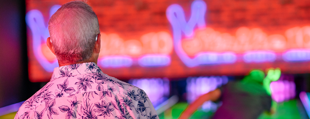 Image of man wearing hearing aids at a bowling alley